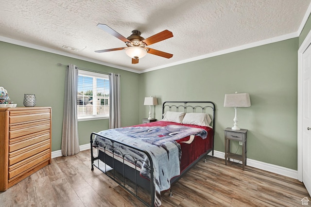 3139 N Pelican Dr, Farr West, UT 84404 - bedroom with wood finished floors, ornamental molding, a textured ceiling, and ceiling fan