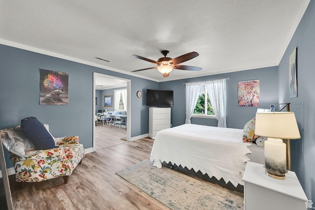 3139 N Pelican Dr, Farr West, UT 84404 - bedroom with ornamental molding, wood finished floors, a textured ceiling, and a ceiling fan