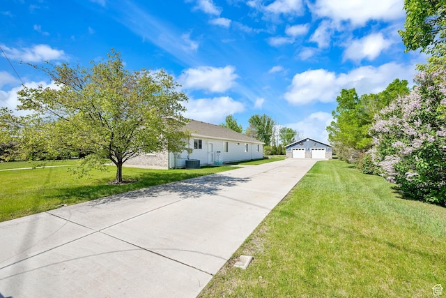3139 N Pelican Dr, Farr West, UT 84404 - view of front of house featuring a garage, an outbuilding, and a front lawn