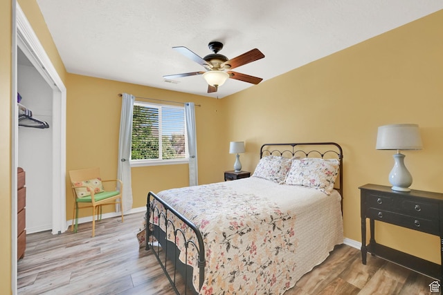 3139 N Pelican Dr, Farr West, UT 84404 - bedroom featuring wood finished floors, a closet, and a ceiling fan