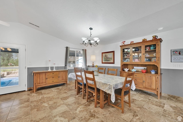 3139 N Pelican Dr, Farr West, UT 84404 - dining space featuring a chandelier, light stone finish floors, and lofted ceiling