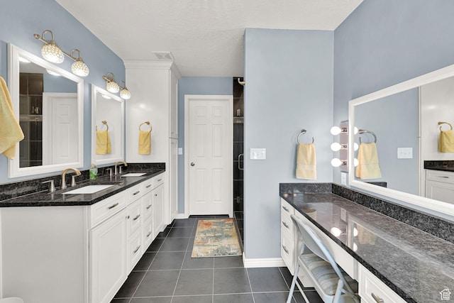3139 N Pelican Dr, Farr West, UT 84404 - bathroom featuring double vanity, tile patterned flooring, and tiled shower