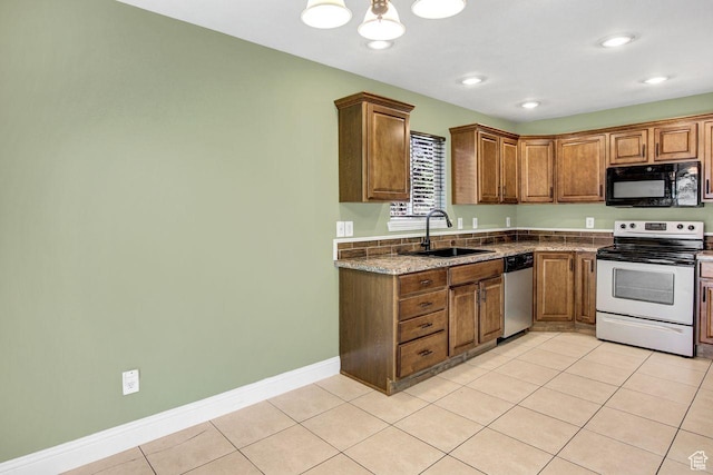 429 W 350 N Unit 4, Tremonton, UT 84337 - kitchen with appliances with stainless steel finishes, light tile patterned flooring, brown cabinets, recessed lighting, and a chandelier