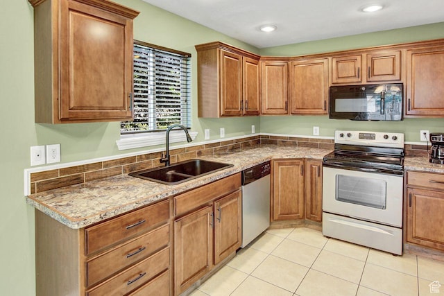 429 W 350 N Unit 4, Tremonton, UT 84337 - kitchen with appliances with stainless steel finishes, light tile patterned floors, and brown cabinetry
