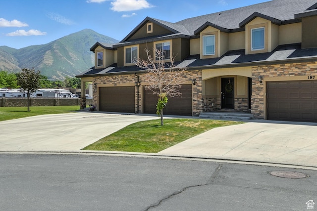 191 E 560 N, Salem, UT 84653 - view of front of home with an attached garage, stucco siding, a mountain view, concrete driveway, and stone siding