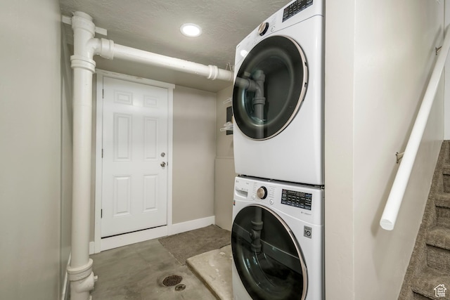 5729 S 150 W, Murray, UT 84107 - washroom featuring stacked washing machine and dryer and baseboards