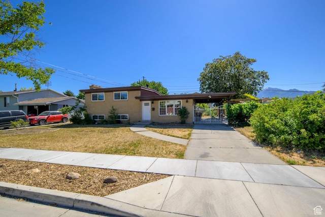 5729 S 150 W, Murray, UT 84107 - split level home with driveway, a carport, and a gate
