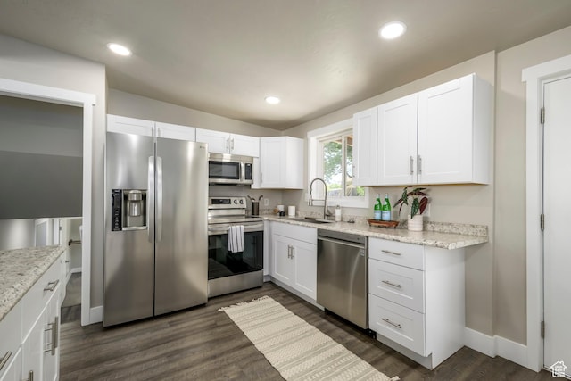 5729 S 150 W, Murray, UT 84107 - kitchen featuring appliances with stainless steel finishes, white cabinetry, dark wood finished floors, and recessed lighting