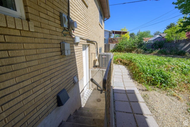 5729 S 150 W, Murray, UT 84107 - view of side of home with brick siding and a central AC unit
