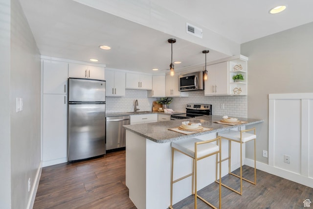 136 E 400 N Unit 207, Provo, UT 84606 - kitchen featuring stainless steel appliances, a peninsula, tasteful backsplash, dark wood-style flooring, and recessed lighting