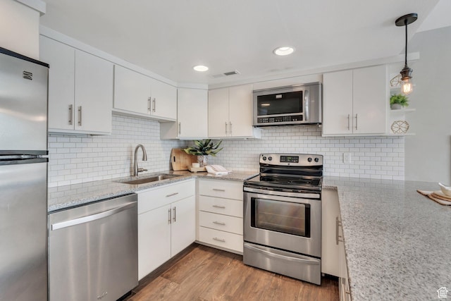 136 E 400 N Unit 207, Provo, UT 84606 - kitchen with stainless steel appliances, white cabinets, wood finished floors, tasteful backsplash, and recessed lighting