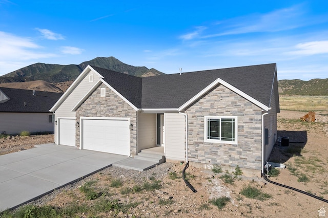 1536 N 300 E Unit 49, Nephi, UT 84648 - craftsman house featuring stone siding, concrete driveway, an attached garage, and a mountain view
