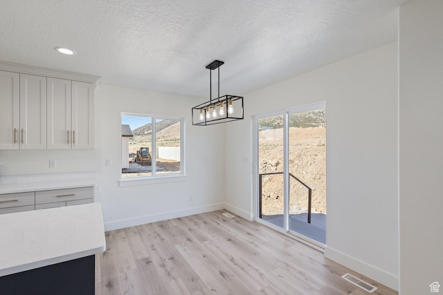 1536 N 300 E Unit 49, Nephi, UT 84648 - unfurnished dining area featuring light wood-type flooring, a chandelier, a textured ceiling, and recessed lighting