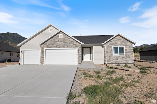 1536 N 300 E Unit 49, Nephi, UT 84648 - view of front of house with stone siding, driveway, a garage, and a mountain view