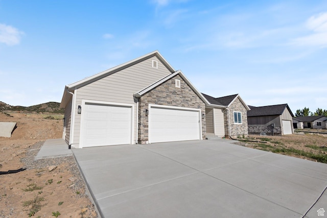 1536 N 300 E Unit 49, Nephi, UT 84648 - view of front of property with a garage, stone siding, and concrete driveway
