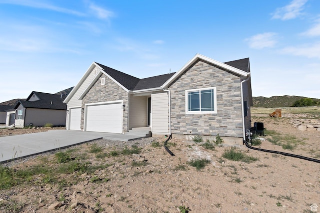 1536 N 300 E Unit 49, Nephi, UT 84648 - view of front of property featuring stone siding, an attached garage, and driveway