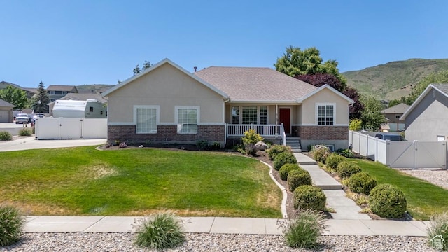 5183 W Heartland Cv, Herriman, UT 84096 - view of front of home featuring a gate, brick siding, covered porch, and stucco siding