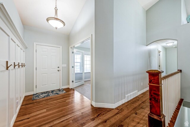 5183 W Heartland Cv, Herriman, UT 84096 - entryway with wood finished floors, arched walkways, and high vaulted ceiling