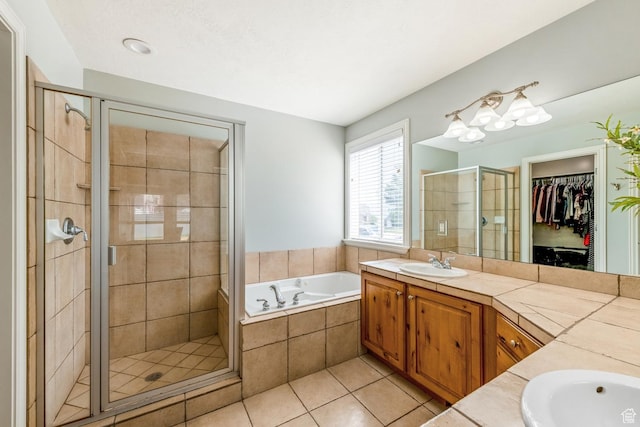 5183 W Heartland Cv, Herriman, UT 84096 - bathroom featuring vanity, a stall shower, a garden tub, tile patterned floors, and a walk in closet