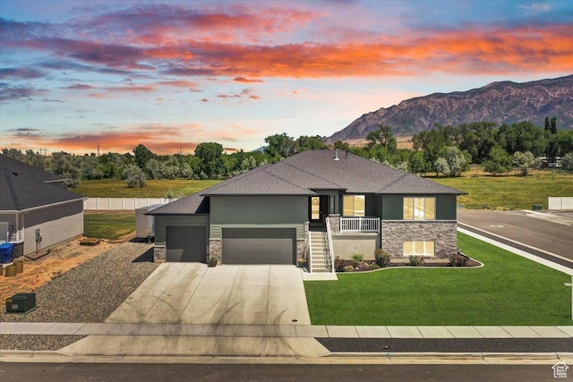 2106 W 2000 N, Farr West, UT 84404 - view of front facade with stone siding, an attached garage, concrete driveway, and a yard