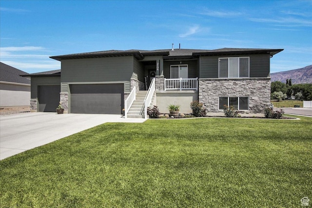 2106 W 2000 N, Farr West, UT 84404 - prairie-style home featuring stone siding, a garage, a front lawn, driveway, and a porch