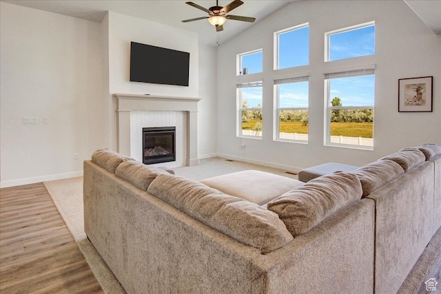 2106 W 2000 N, Farr West, UT 84404 - living area with wood finished floors, a ceiling fan, a glass covered fireplace, and lofted ceiling