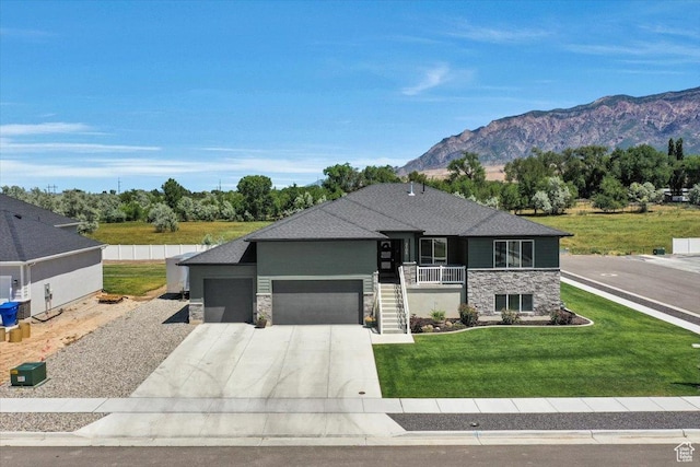2106 W 2000 N, Farr West, UT 84404 - view of front of house featuring stone siding, an attached garage, driveway, and a front yard