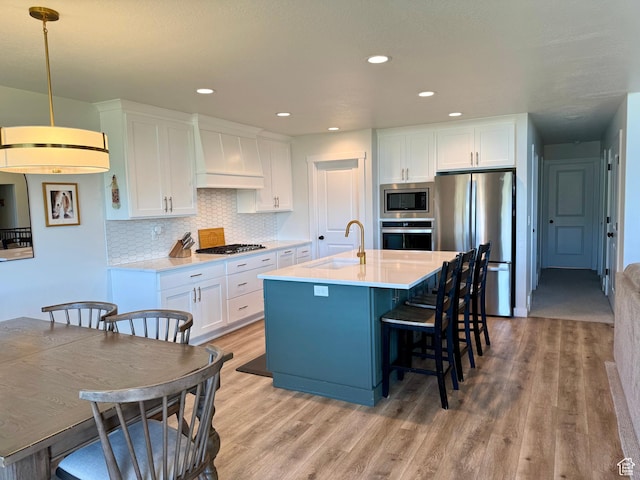 2106 W 2000 N, Farr West, UT 84404 - kitchen with stainless steel appliances, custom range hood, light wood-style flooring, light countertops, and recessed lighting