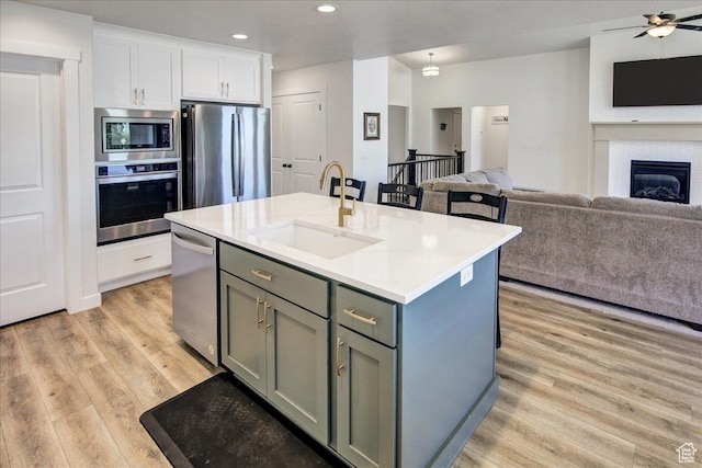 2106 W 2000 N, Farr West, UT 84404 - kitchen with appliances with stainless steel finishes, light wood-style floors, gray cabinets, open floor plan, and recessed lighting