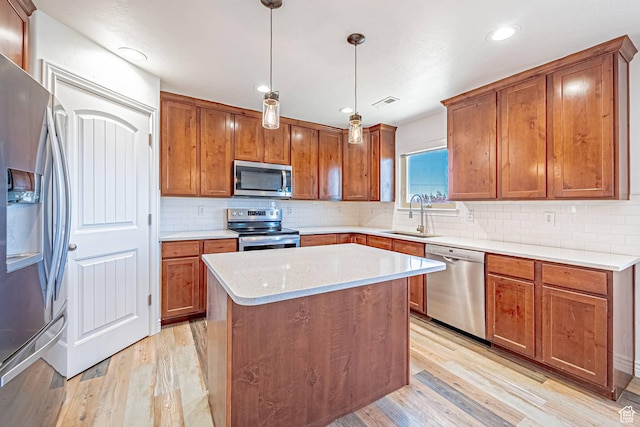 6563 S Days End Ct, West Jordan, UT 84081 - kitchen with stainless steel appliances, light wood-type flooring, brown cabinets, and recessed lighting