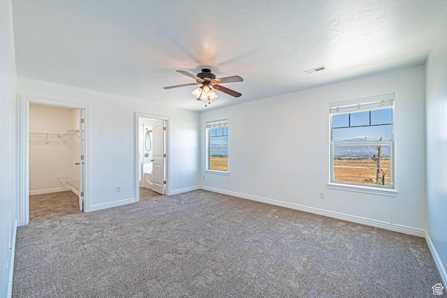 6563 S Days End Ct, West Jordan, UT 84081 - unfurnished bedroom featuring carpet floors, a spacious closet, and multiple windows