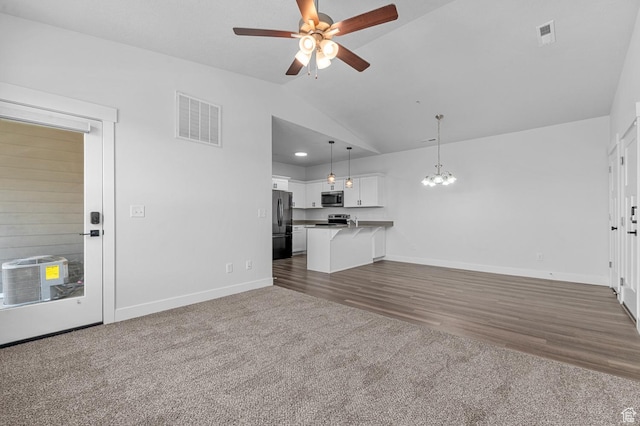 3667 W Canyon Falls Dr Unit S301, Lehi, UT 84043 - unfurnished living room with a ceiling fan, dark carpet, vaulted ceiling, a chandelier, and dark wood-style floors