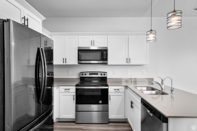 3667 W Canyon Falls Dr Unit S301, Lehi, UT 84043 - kitchen with stainless steel appliances, a peninsula, dark wood-type flooring, light stone countertops, and white cabinets