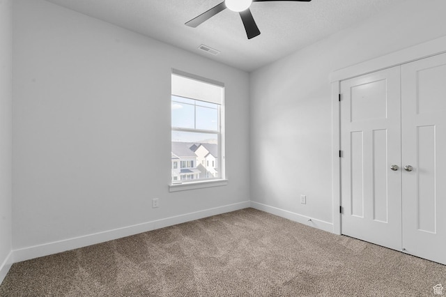 3667 W Canyon Falls Dr Unit S301, Lehi, UT 84043 - unfurnished bedroom with carpet flooring, a closet, a ceiling fan, and a textured ceiling