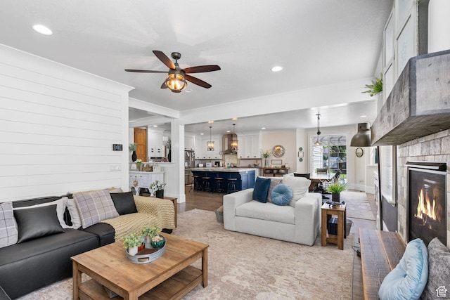 1046 W 1100 N, Pleasant Grove, UT 84062 - living room featuring a ceiling fan, a brick fireplace, recessed lighting, crown molding, and light wood-style floors