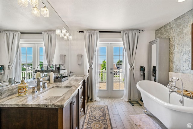 1046 W 1100 N, Pleasant Grove, UT 84062 - full bathroom with plenty of natural light, a freestanding bath, a chandelier, and double vanity
