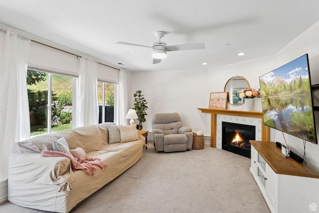 2401 N 1400 E, Layton, UT 84040 - carpeted living room with a glass covered fireplace, ceiling fan, and recessed lighting