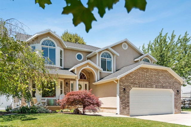 2401 N 1400 E, Layton, UT 84040 - traditional home featuring an attached garage, stucco siding, driveway, and a front lawn