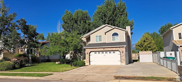 5256 S 3400 W, Roy, UT 84067 - view of front facade with an attached garage, concrete driveway, a chimney, and brick siding