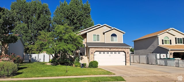 5256 S 3400 W, Roy, UT 84067 - view of front of home featuring concrete driveway, an attached garage, and brick siding