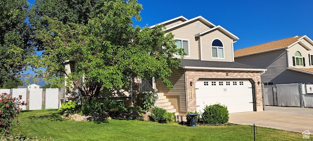 5256 S 3400 W, Roy, UT 84067 - view of front of house featuring concrete driveway, a garage, and brick siding