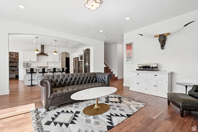 67 N 300 E, Vineyard, UT 84059 - living area featuring arched walkways, stairs, wood finished floors, and recessed lighting