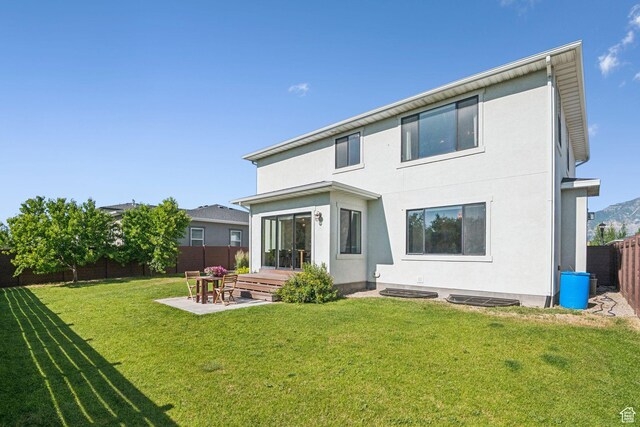 67 N 300 E, Vineyard, UT 84059 - rear view of house featuring a fenced backyard, a patio area, and stucco siding