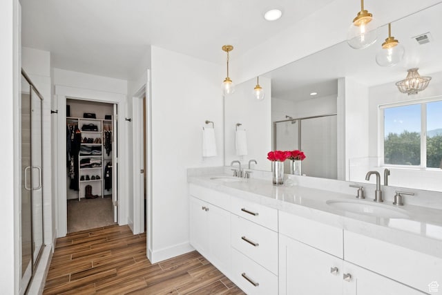 67 N 300 E, Vineyard, UT 84059 - full bathroom with a shower stall, wood finished floors, a spacious closet, double vanity, and recessed lighting