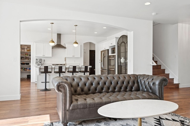 67 N 300 E, Vineyard, UT 84059 - living area with arched walkways, light wood-style flooring, recessed lighting, and stairway