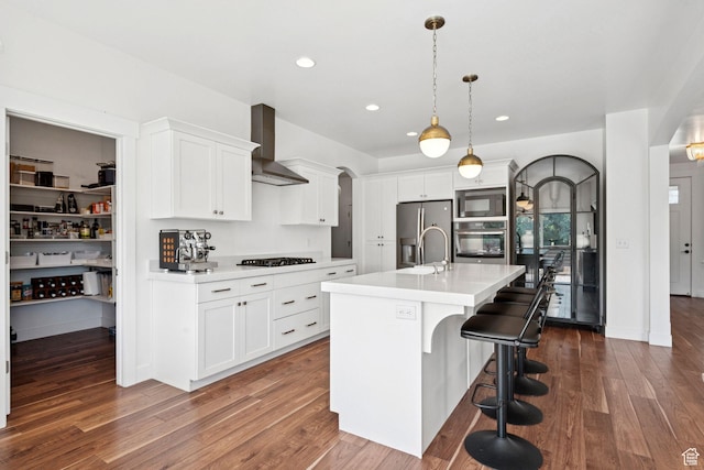 67 N 300 E, Vineyard, UT 84059 - kitchen with black appliances, wall chimney range hood, arched walkways, light countertops, and recessed lighting