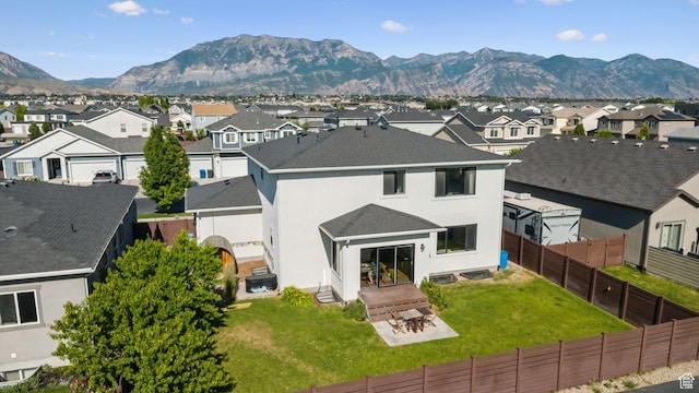 67 N 300 E, Vineyard, UT 84059 - back of property featuring a residential view, a mountain view, stucco siding, a fenced backyard, and a shingled roof