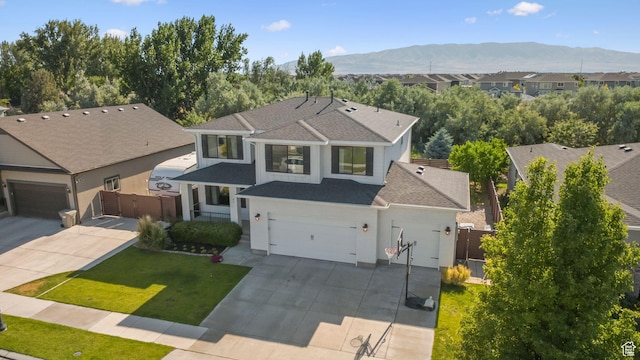 67 N 300 E, Vineyard, UT 84059 - traditional home with concrete driveway, a mountain view, stucco siding, a gate, and a shingled roof