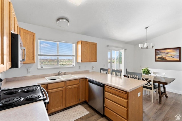 2144 E Easter Dr, Eagle Mountain, UT 84005 - kitchen featuring stainless steel appliances, a peninsula, light wood finished floors, a chandelier, and light countertops