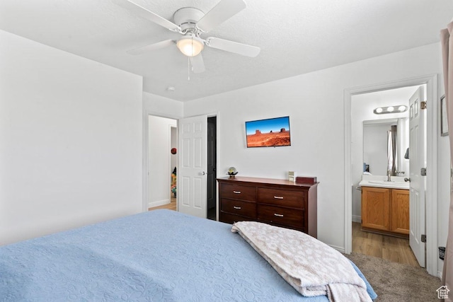 2144 E Easter Dr, Eagle Mountain, UT 84005 - bedroom with ensuite bathroom, wood finished floors, and ceiling fan